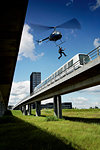 Man jumping from helicopter to train