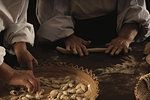 Chefs rolling gnocchi dough in kitchen