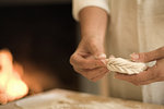 Cook folding filled pasta in kitchen