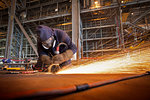 Steel cutter at work in shipyard