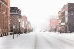 Snow falling on city street