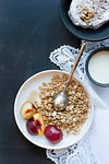 Plate of oatmeal with fruit and cream