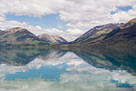 Clouds and sky reflected in still lake