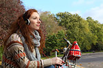 Woman listening to headphones in park