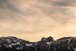 Colorful sky over snowy mountains