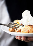 Plate of apple pie with cream