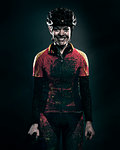 Mud splattered cyclist smiling