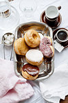 Tray of donuts with coffee and sugar