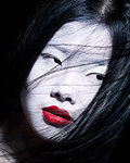 Young woman with dramatic makeup, white face and red lipstick