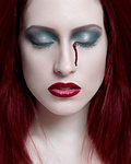 Portrait of young woman with eye bleeding