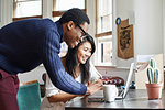 Young couple using laptop at home