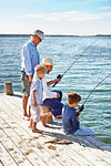 Boys with father and grandfather fishing, Utvalnas, Sweden