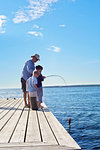 Grandfather and grandsons fishing, Utvalnas, Sweden