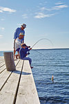 Boy with father and grandfather fishing, Utvalnas, Sweden