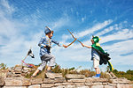 Two boys in fancy dress play fighting with sticks, Eggergrund, Sweden