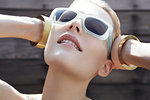 Close up of young woman with head back sunbathing