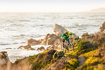 Mountain biker moving up coastal path, Monterey Bay area, California, USA