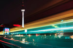 Night time view of moving train and television tower, Berlin, Germany