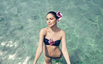 Beautiful young woman with eyes closed standing in Lake Attesee, Austria