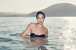 Portrait of sultry young woman standing in Lake Attesee, Austria