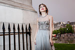 Female model in evening gown at dusk, Trafalgar Square, London, UK