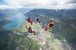 Team of four skydivers in formation over Interlaken, Berne, Switzerland