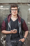 Teenage boy with headphones and smartphone