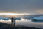 Woman with surfboard, Jokulsarlon Glacier Lagoon, Skaftafell National Park, Iceland