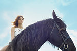 Portrait of young woman on horse