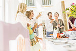 Family raising a toast at dining table