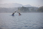 Family canoeing on lake, Staffelsee, Murnau, Oberbayern, Bavaria, Germany