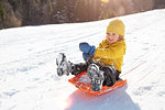 Boy tobogganing