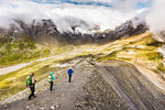 High angle view of male and female hikers hiking, Fil de Cassons, Segnesboden, Graubunden, Switzerland