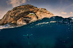 Woman underwater with arch, Santany, Mallorca, Spain