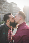 Gay couple kissing on street