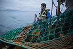 Fisherman preparing net, Isle of Skye, Scotland