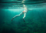 Underwater view of mid adult woman swimming, Menorca, Balearic islands, Spain
