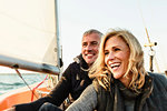 Mature couple on sailing boat, smiling