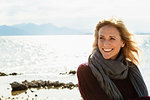 Portrait of mature woman beside lake, smiling