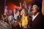 Group of friends watching performance in club