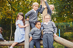 Portrait of elementary schoolchildren on playground climbing frame