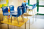 Empty classroom with chairs on desk in elementary school