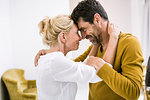 Romantic mature couple face to face in living room