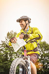 Low angle view of mature male mountain biker with map