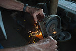 Man sharpening knife in machine shop