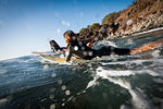 Surfers paddling in ocean