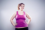 Young woman wearing purple vest, hands on hips