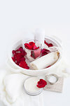 Candles and rose petals in dish