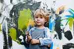 Little boy in front of his painting