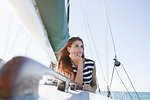 Young woman on yacht wearing striped top